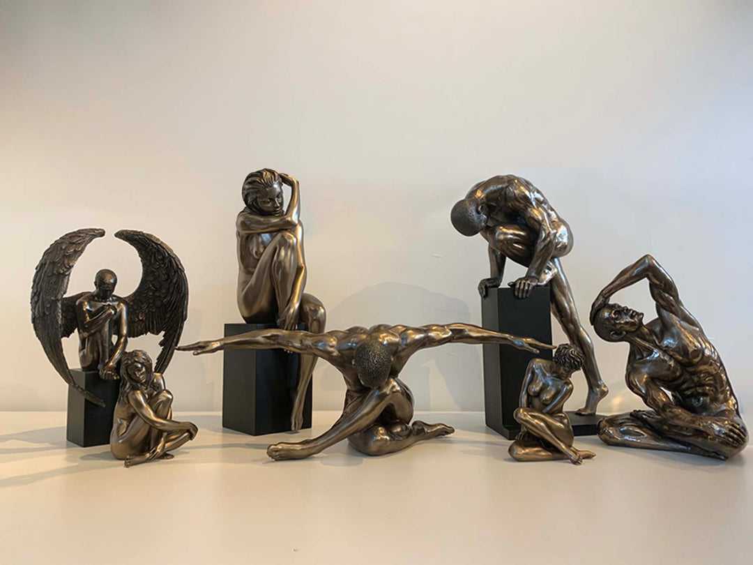 Bronze male female arm outstretch man sculptures