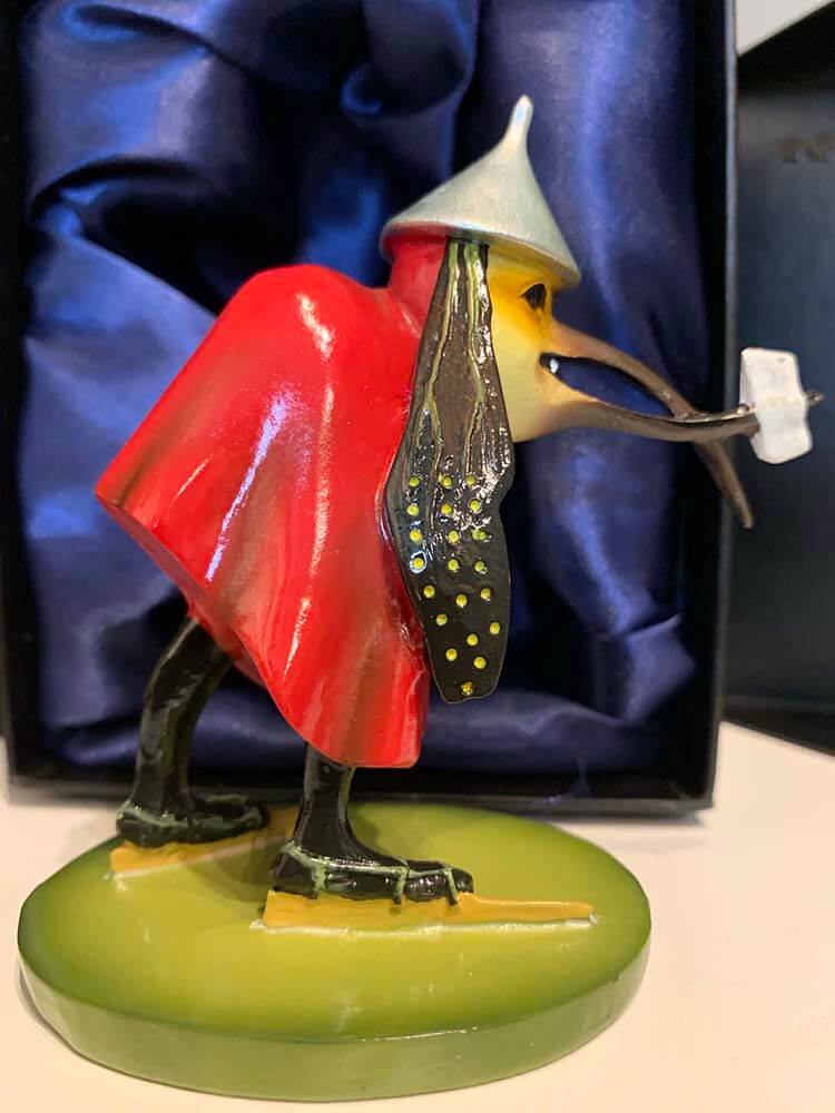 The postman-like monstrosity delivering a letter to the conspiring figures in the hole under the bridge.