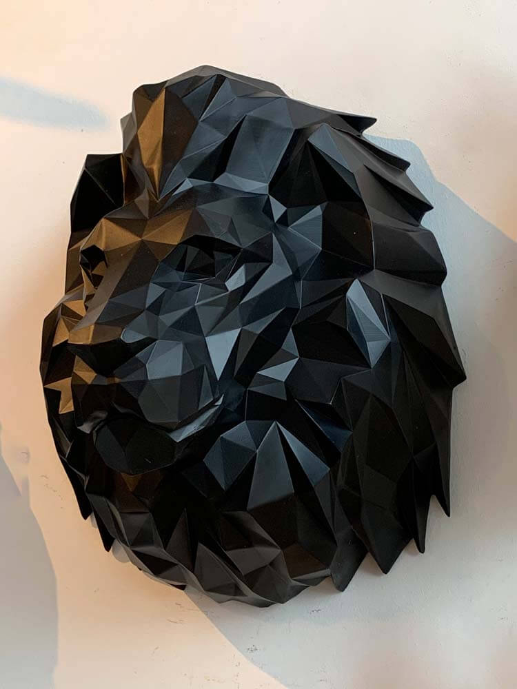 Geometric black lion head sculpture