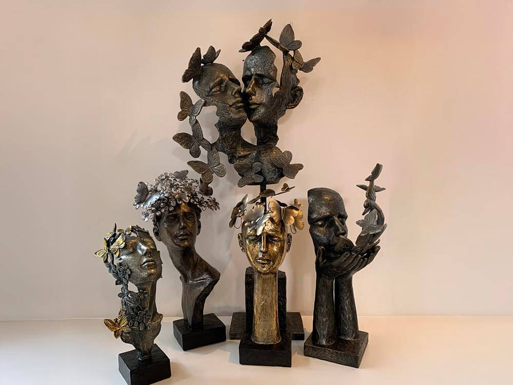 Artistic sculptures with Female faces with butterflies on  face and head, The Dutch Hospital