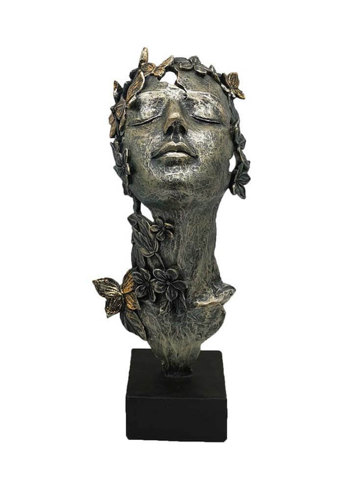 Bronze sculpture of a woman's head with floral and butterfly details