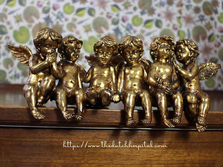 set of sitting and talking cherubs, gold colour painted resin angel figures