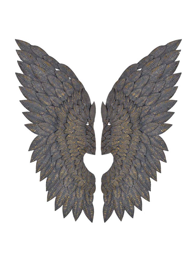 Large pair of feather effect metal wings above the bed