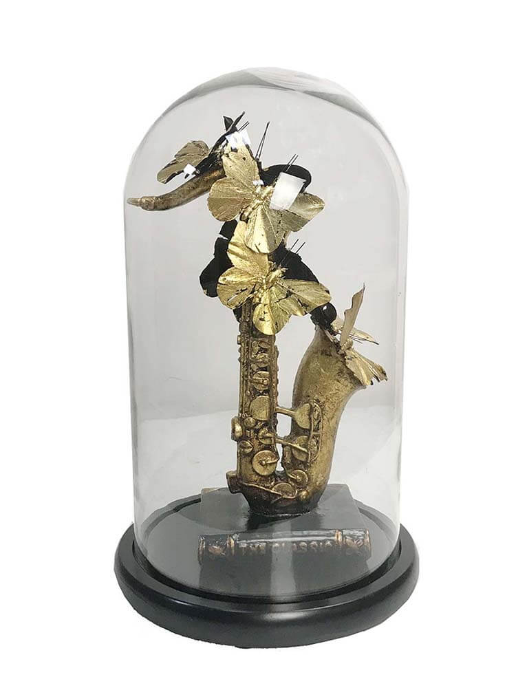 Gold saxophone sculpture inside a clear glass dome, black gold faux butterflies