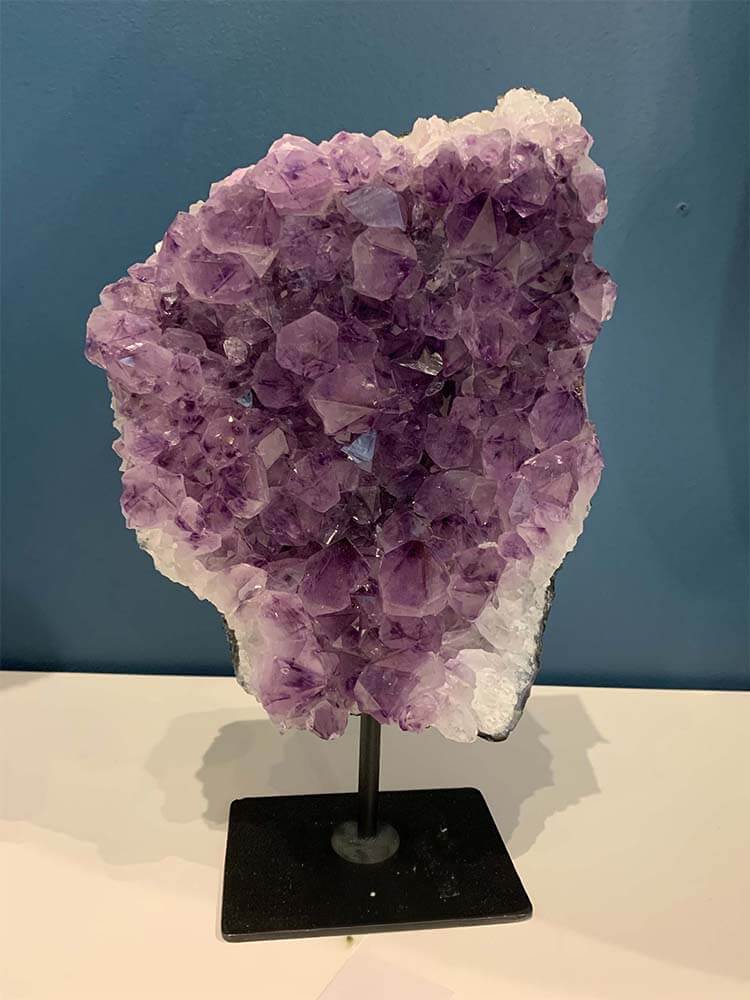 Amethyst crystal on a stand