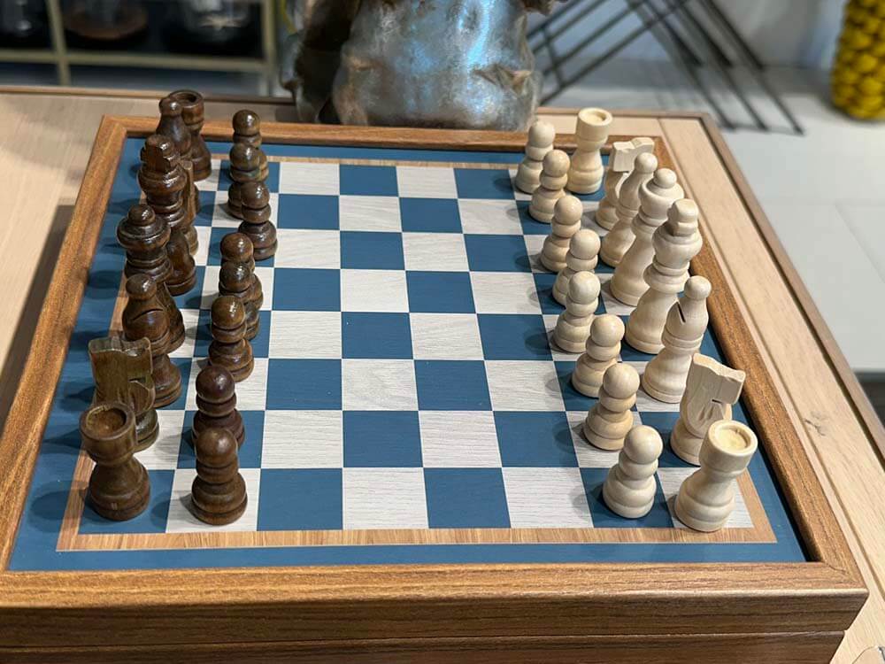 Wooden chessboard with pieces on a checkered surface Blue white brown