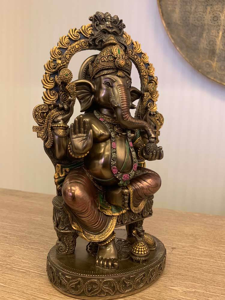 Decorative statue of a seated Ganesh god

