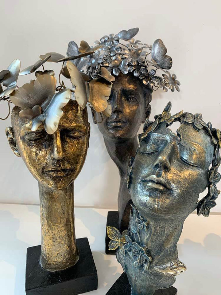 Female faces with butterflies on  face sculptures Bronze Silver Gold, The Dutch Hospital