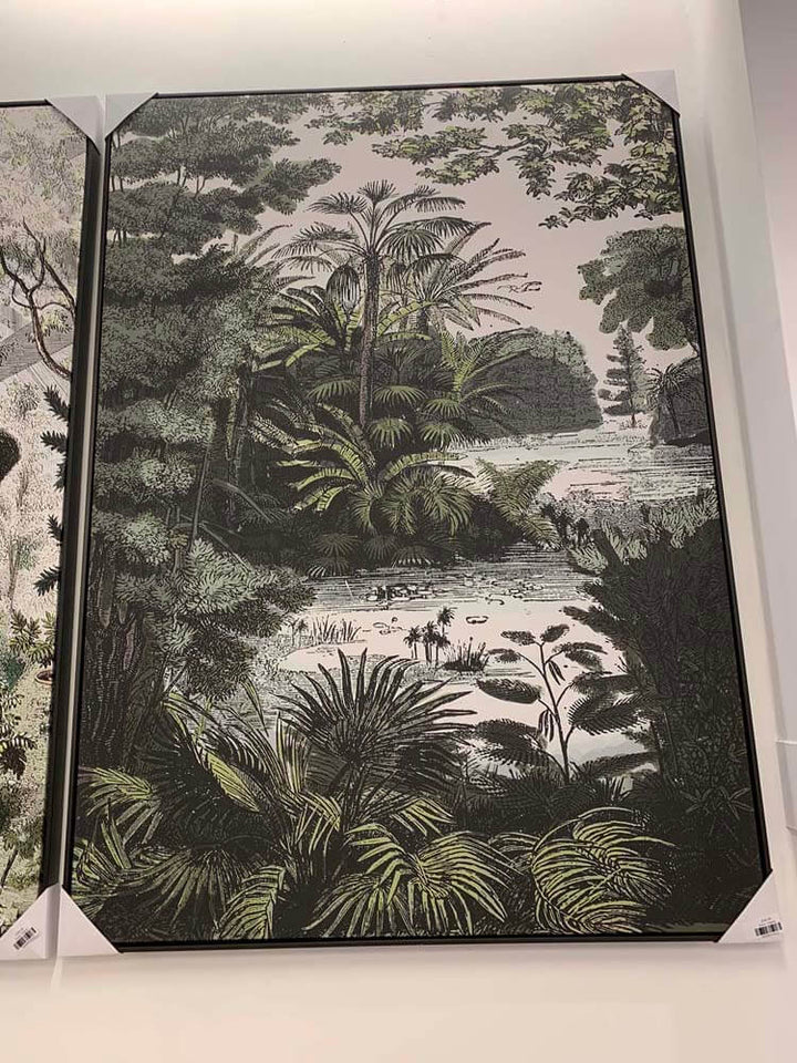 Framed artwork of a tropical landscape with palm trees and water  