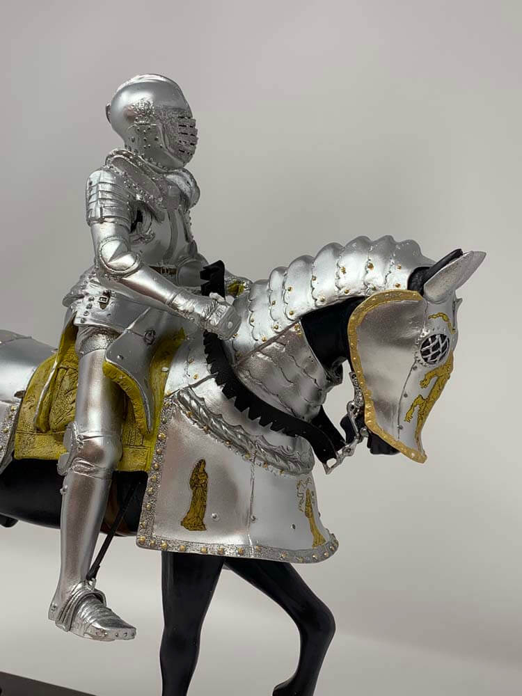 statue of a knight in full armour on a horse 
