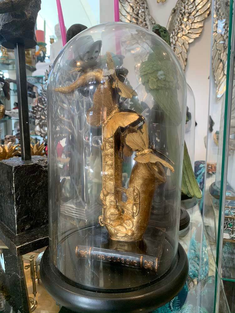 Gold saxophone sculpture inside a clear glass dome, black gold faux butterflies by Dutch Hospital