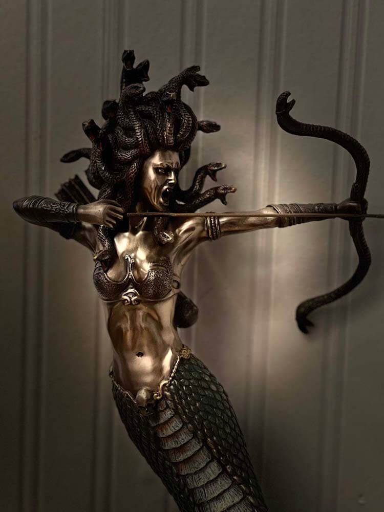 Bronze Medusa sculpture featuring snake hair and a mermaid body