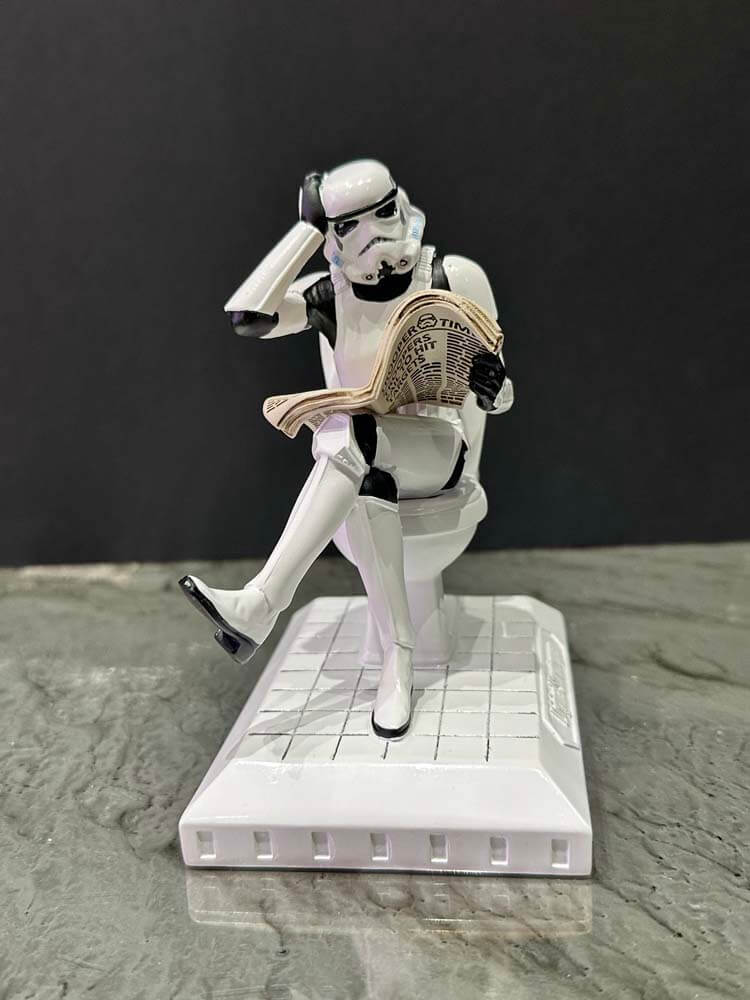 Star Wars Stormtrooper white figurine Sitting on the Toilet and Reading a Newspaper