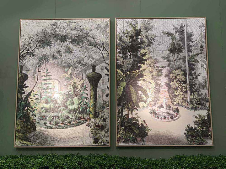 Framed wall art featuring a tropical garden with palm trees.