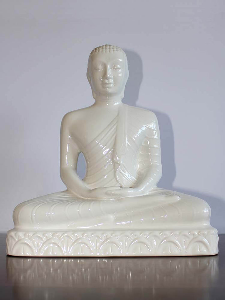White ceramic statue of a seated Buddha figure, meditation Buddha statue