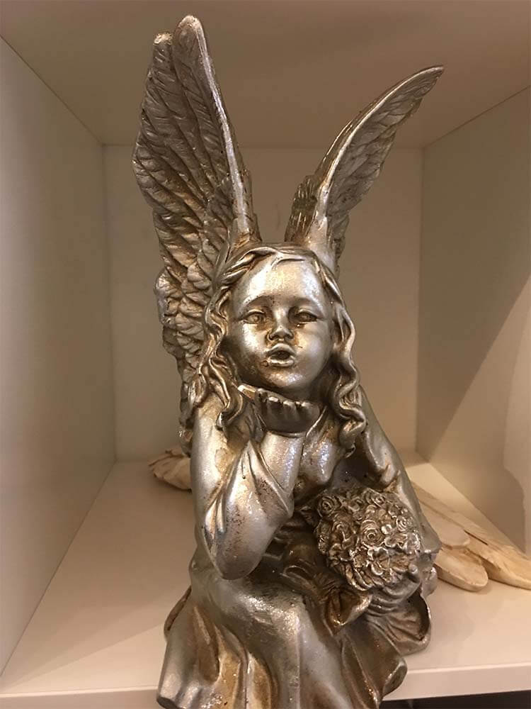 Angel sculpture, sitting angel on a shelf, silver