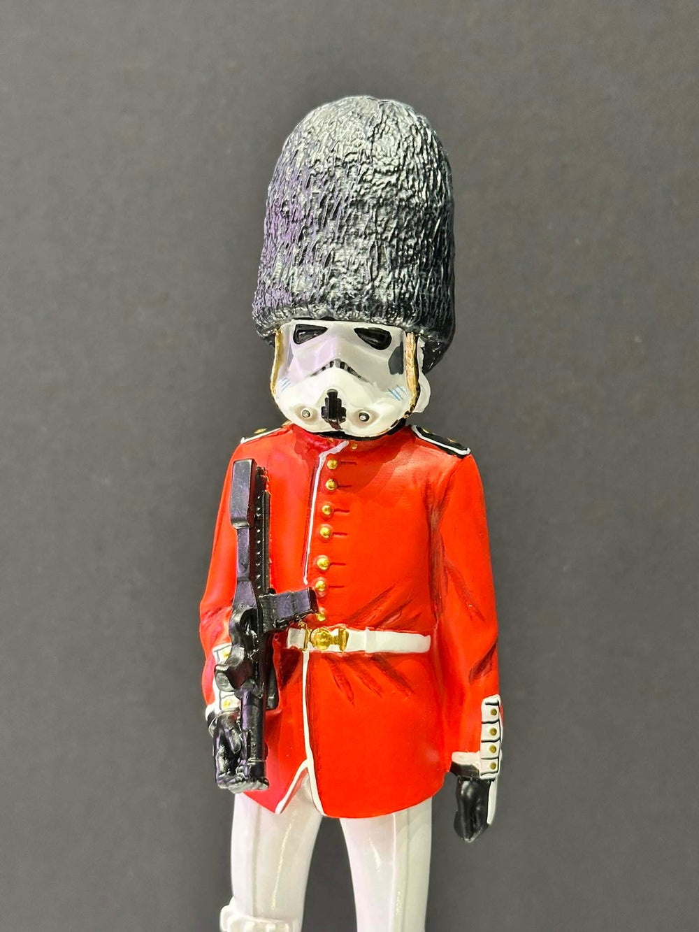 Figure of a stormtrooper in a red uniform with a helmet , Buckingham Palace Guards 
