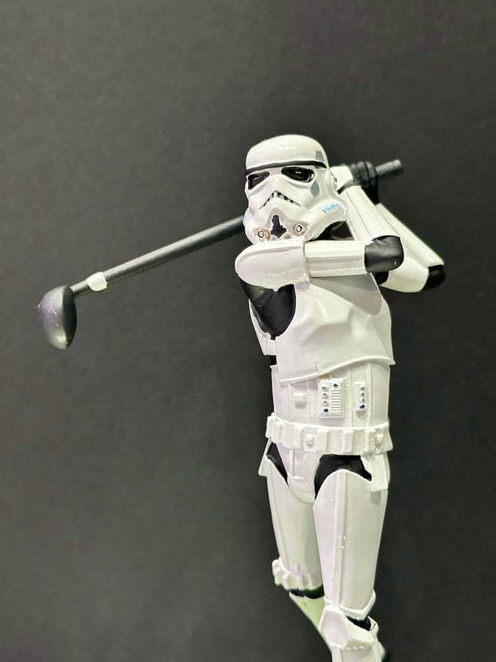 Stormtrooper figure from Star Wars holding a golf club 