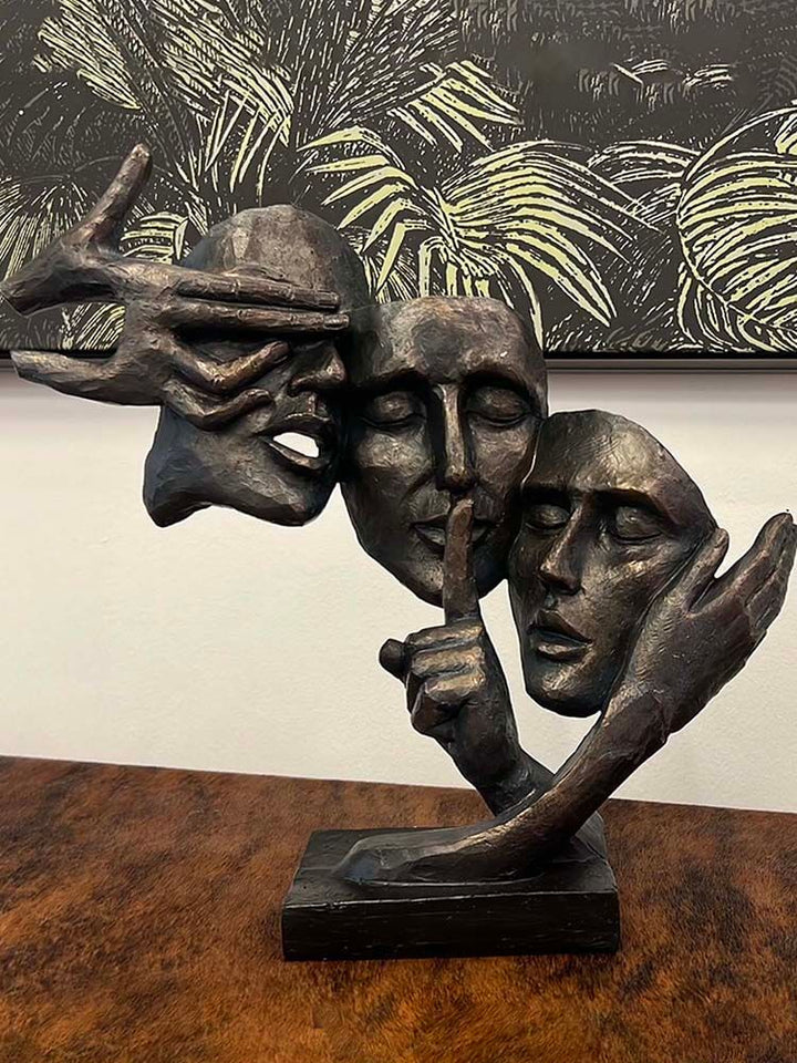 three female faces statue