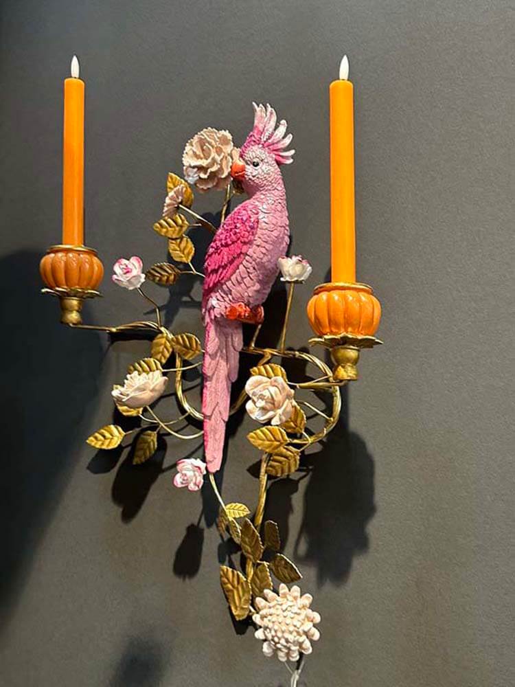 Wall decor candle holders showcasing a beautiful pink, gold and orange parrot 