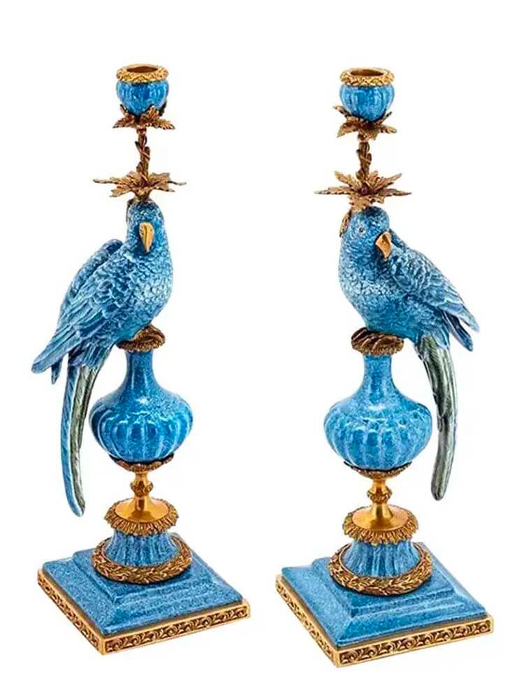 Pair of decorative candle holders with blue parrot designs 