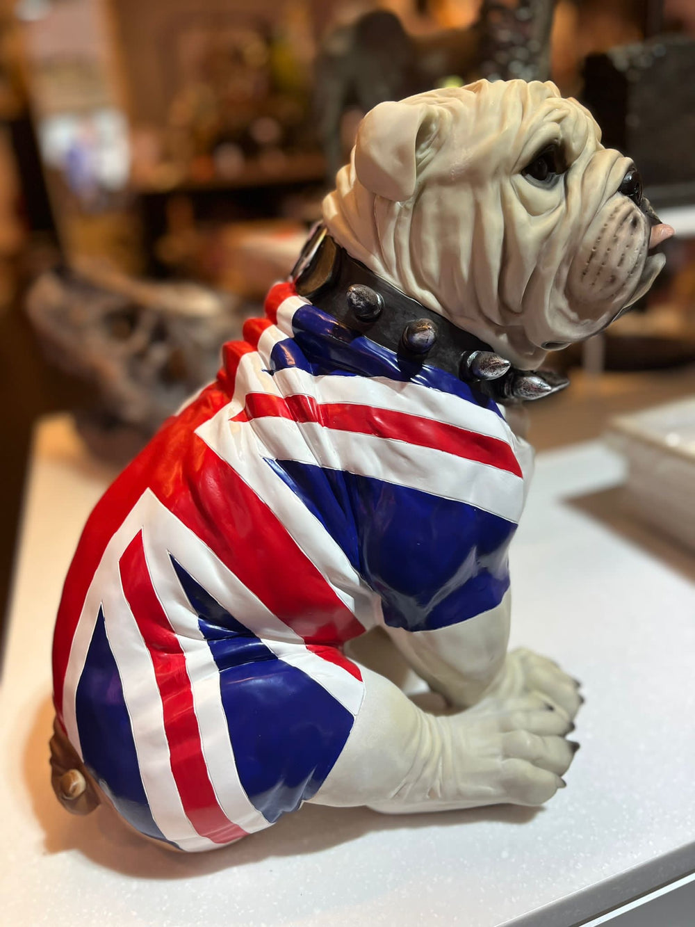 Large sitting English bulldog in Union Flag coat