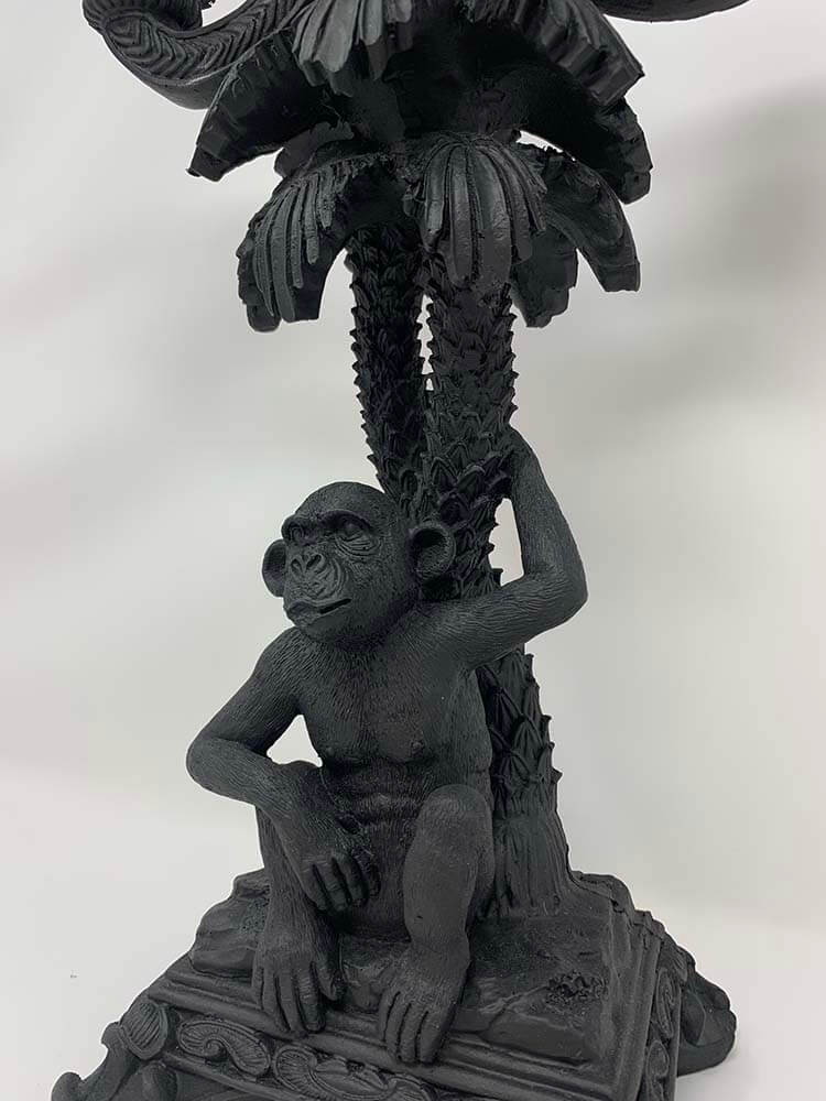 Black monkey statue with a palm tree candle stick