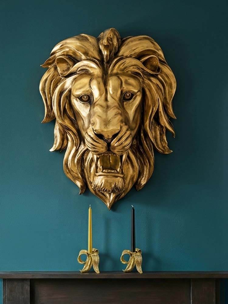 A large, ornate gold lion head wall sculpture mounted