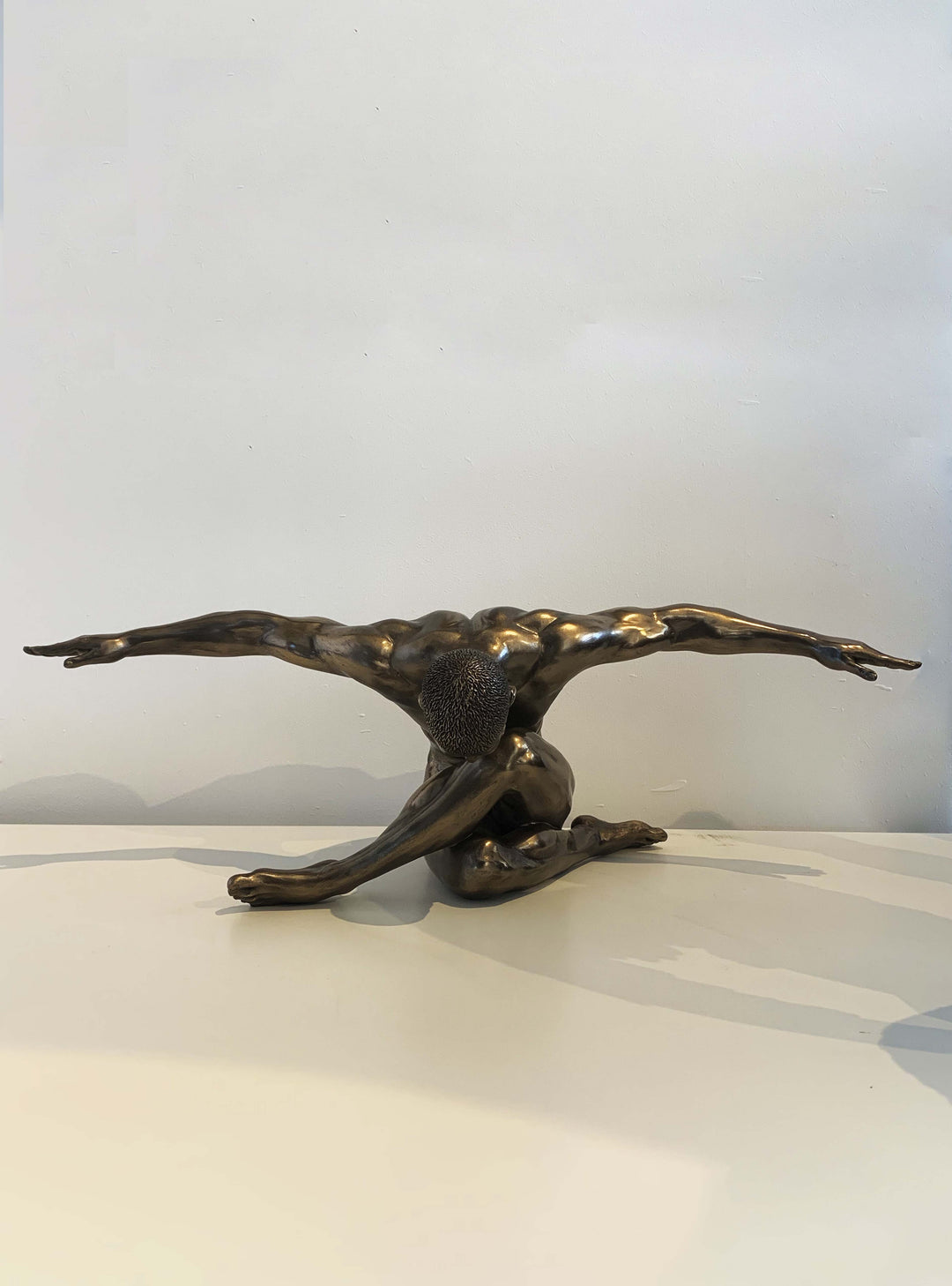 male-nude-arms-outstretched-oversized-sculpture-nude-female-figurine-crouching-nude-bronze-sculpture