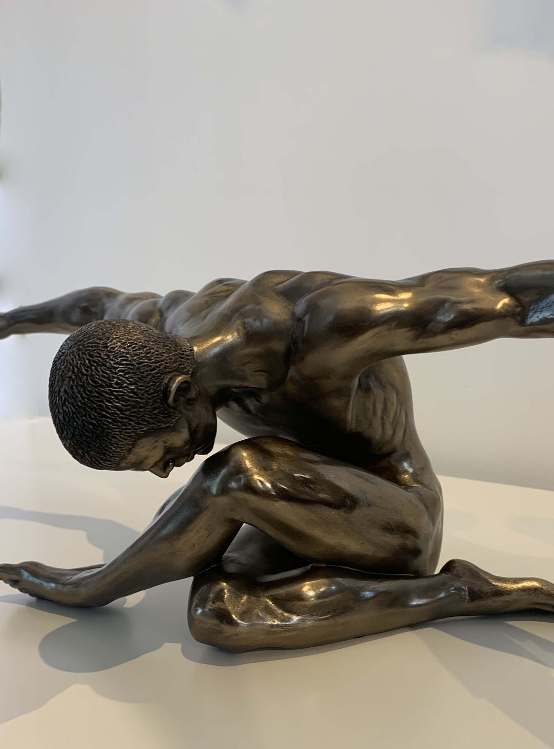 Libra-keswick-male-nude-arms-outstretched-oversized-sculpture-nude-female-figurine-crouching-nude-bronze-sculpture